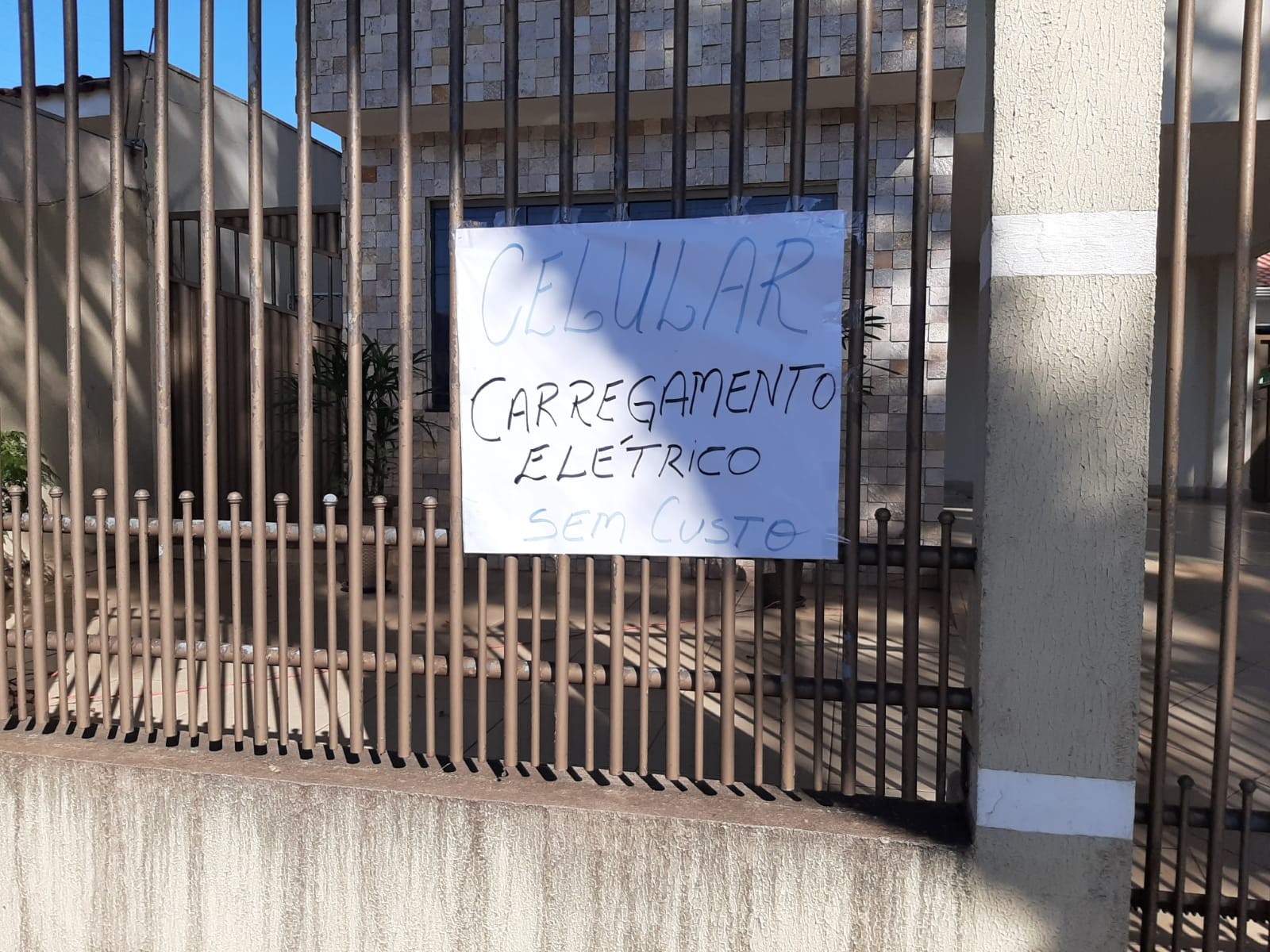 Morador coloca tomada no portão de casa para pessoas sem energia carregarem celular em Maringá